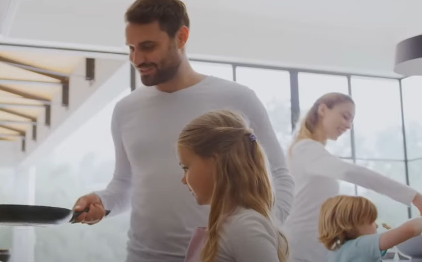 happy man with family cooking after taking a partial hospitalization program