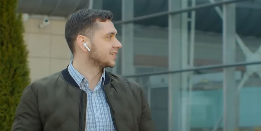 happy man near a building after taking cocaine addiction treatment