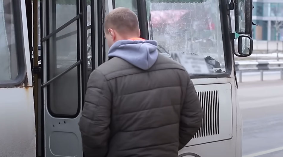 sad man getting on the bus